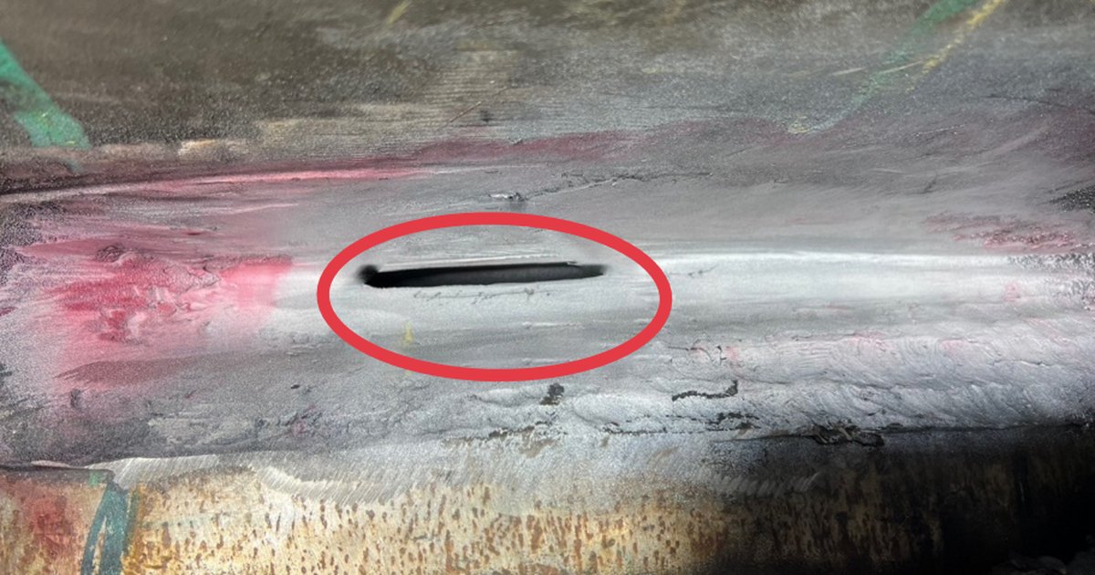 Excavated weld root with an open void circled in red